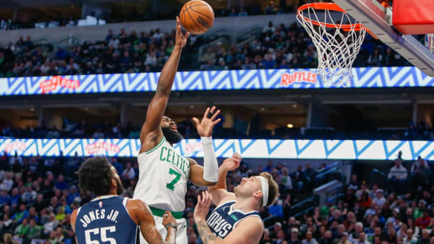 Jan 22, 2024; Dallas, Texas, USA; Boston Celtics guard Jaylen Brown (7) shoots over Dallas Mavericks guard Luka Doncic (77) during the first quarter at American Airlines Center.
